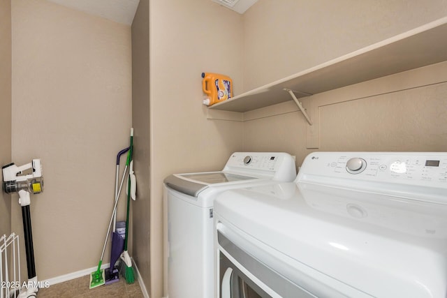 clothes washing area with washing machine and clothes dryer