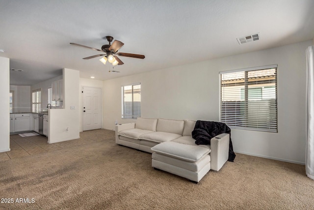 living room featuring ceiling fan and light colored carpet