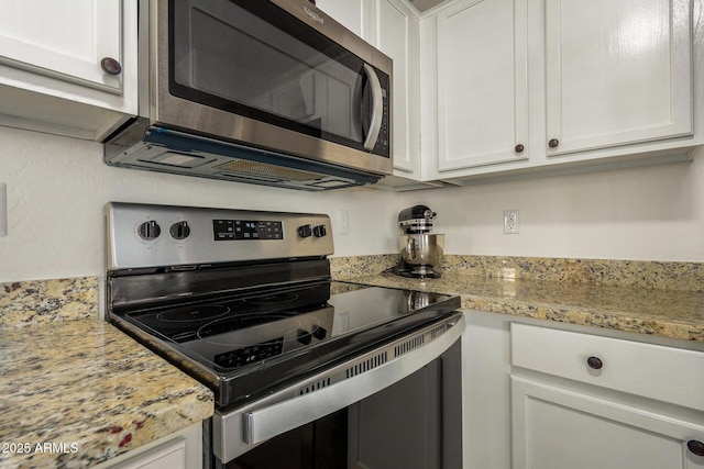 kitchen featuring light stone counters, white cabinetry, and appliances with stainless steel finishes