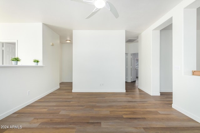 unfurnished room with ceiling fan and dark hardwood / wood-style flooring