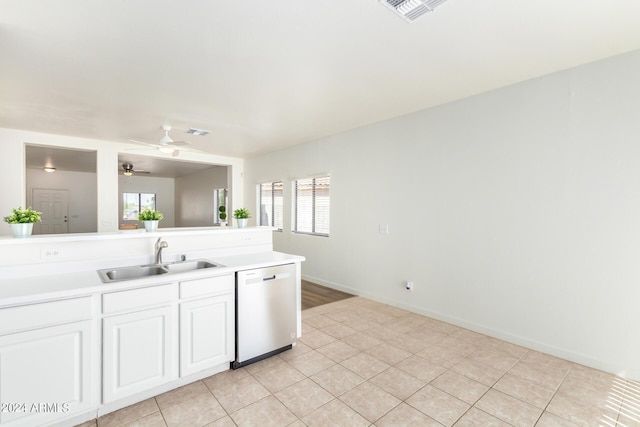 kitchen with light tile patterned flooring, white cabinetry, sink, stainless steel dishwasher, and ceiling fan