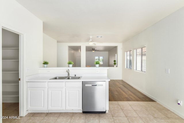 kitchen with light tile patterned flooring, sink, dishwasher, ceiling fan, and white cabinets