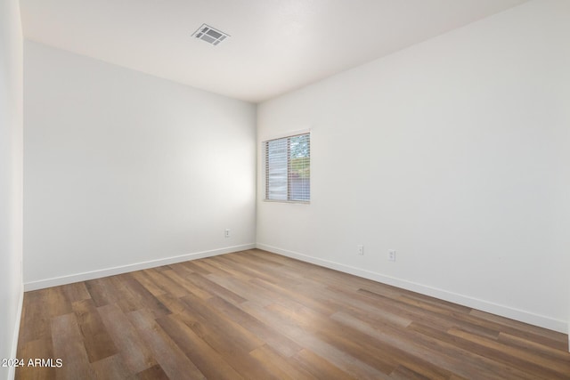 unfurnished room with hardwood / wood-style flooring