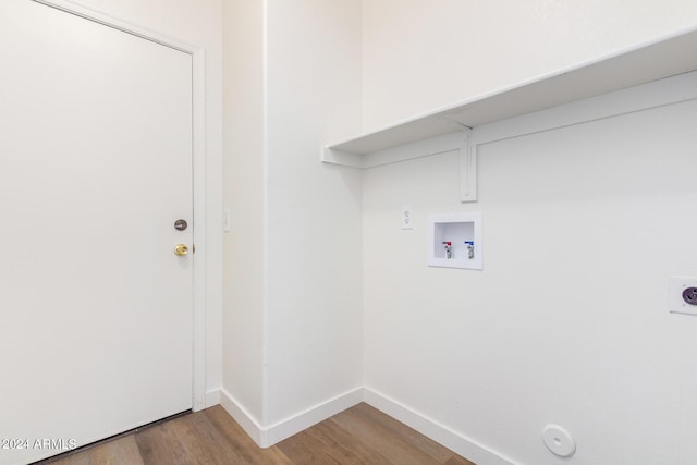 laundry room featuring electric dryer hookup, hookup for a washing machine, hardwood / wood-style flooring, and hookup for a gas dryer