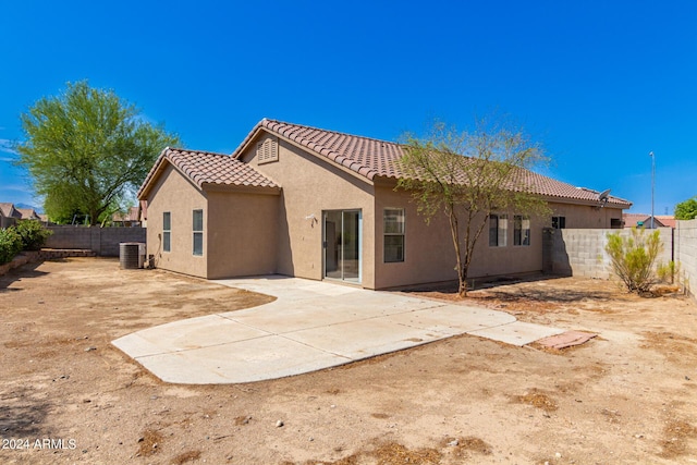 back of property with cooling unit and a patio area