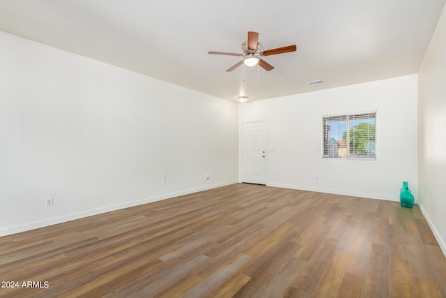 spare room with wood-type flooring and ceiling fan