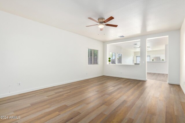 empty room featuring ceiling fan and hardwood / wood-style floors