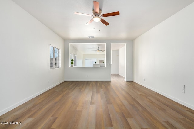 unfurnished living room featuring hardwood / wood-style floors and ceiling fan