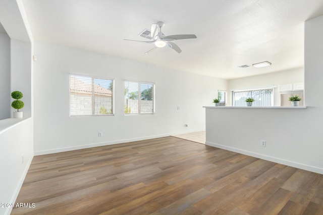 spare room with hardwood / wood-style floors and ceiling fan