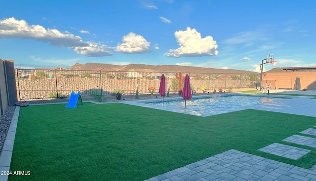 exterior space featuring basketball hoop and a fenced in pool