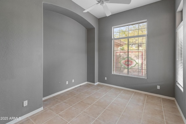 spare room with light tile patterned flooring and ceiling fan