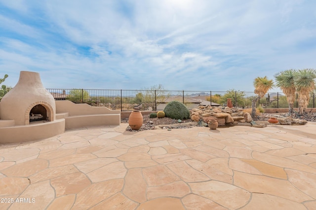 view of patio / terrace featuring an outdoor fireplace