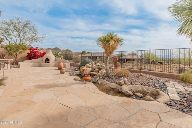 view of patio / terrace featuring an outdoor fireplace