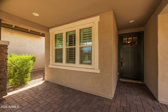 entrance to property with stucco siding