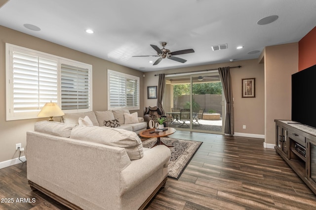 living room featuring baseboards, dark wood finished floors, and visible vents