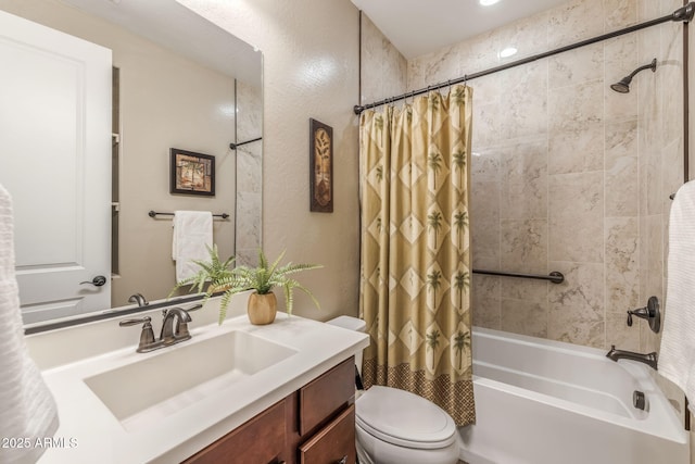 bathroom with vanity, shower / tub combo with curtain, a textured wall, and toilet