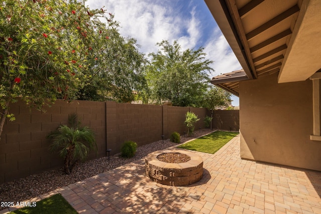 view of patio with a fenced backyard and a fire pit