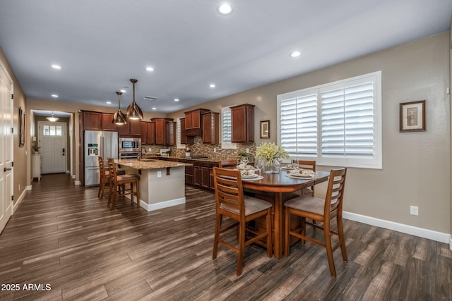 dining space with dark wood-style flooring, baseboards, and recessed lighting