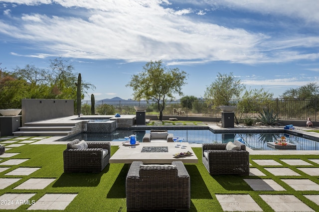 view of swimming pool featuring an in ground hot tub, an outdoor fire pit, a patio area, and a lawn