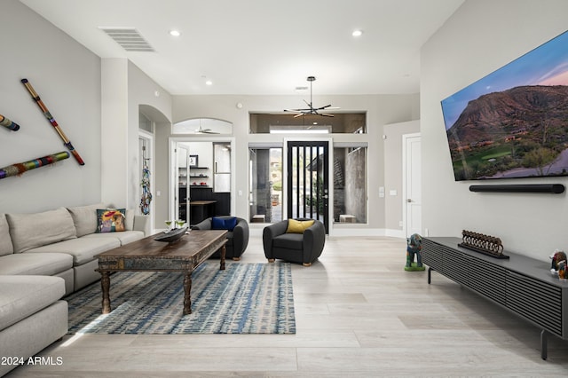 living room featuring a chandelier and light hardwood / wood-style floors