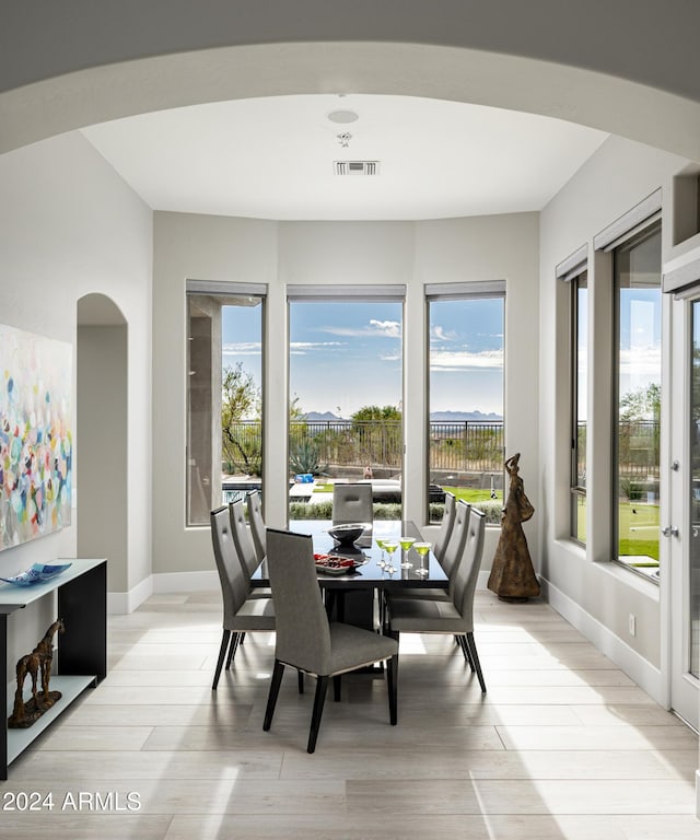 dining area with a healthy amount of sunlight and light hardwood / wood-style floors