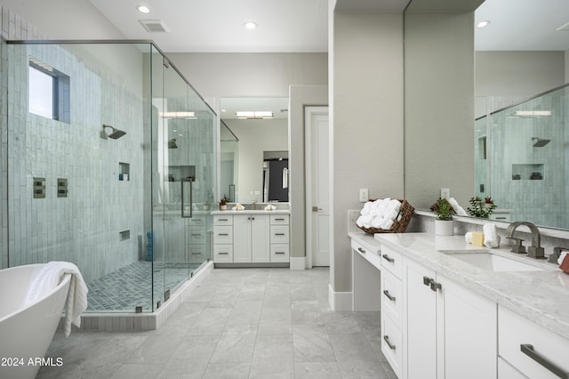 bathroom with vanity and independent shower and bath