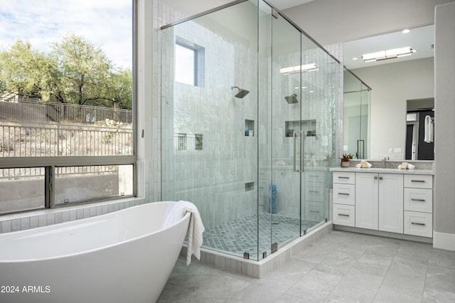 bathroom with vanity and separate shower and tub