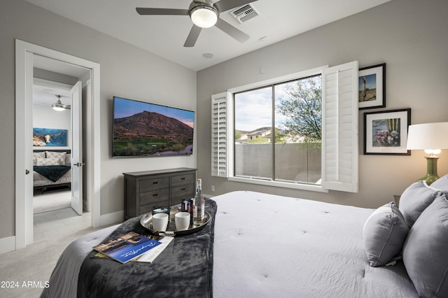 bedroom featuring ceiling fan and light carpet