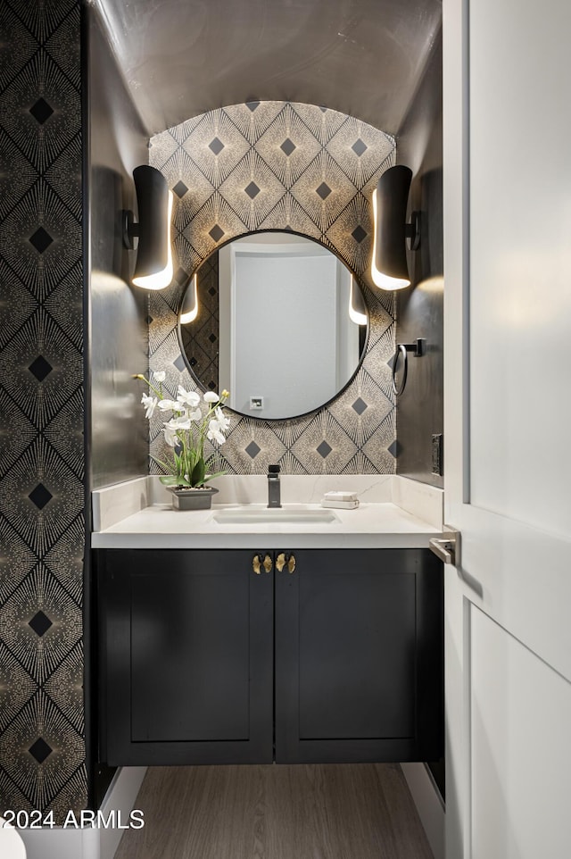 bathroom with hardwood / wood-style floors and vanity