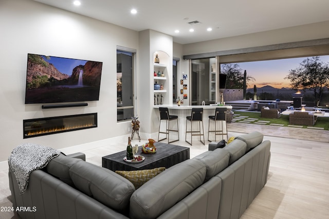 living room featuring light hardwood / wood-style floors and built in features