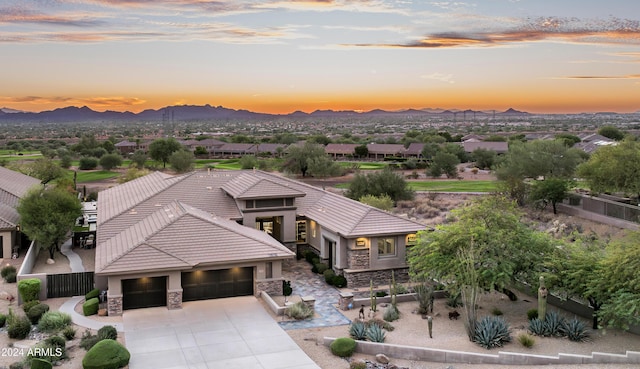 aerial view at dusk featuring a mountain view