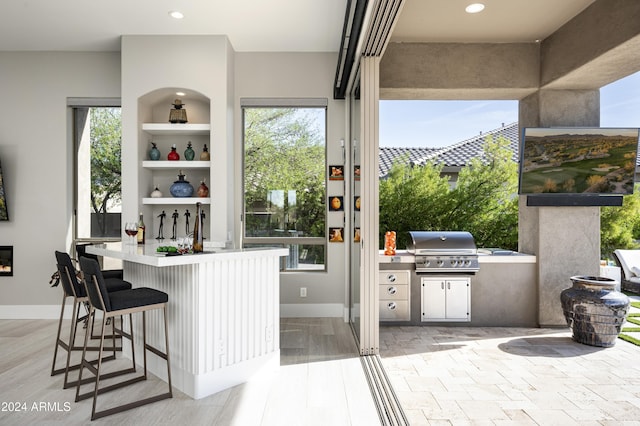 interior space featuring built in shelves and a kitchen breakfast bar