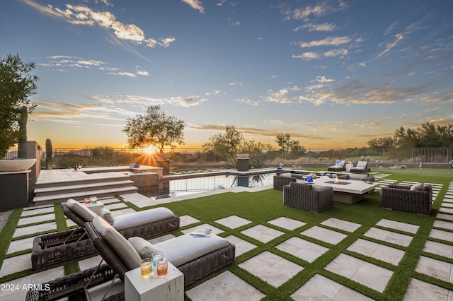 yard at dusk with a fenced in pool, an outdoor hangout area, and a patio