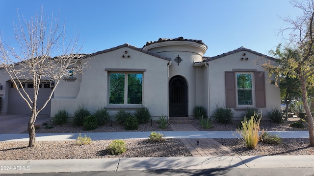 mediterranean / spanish-style home with a garage