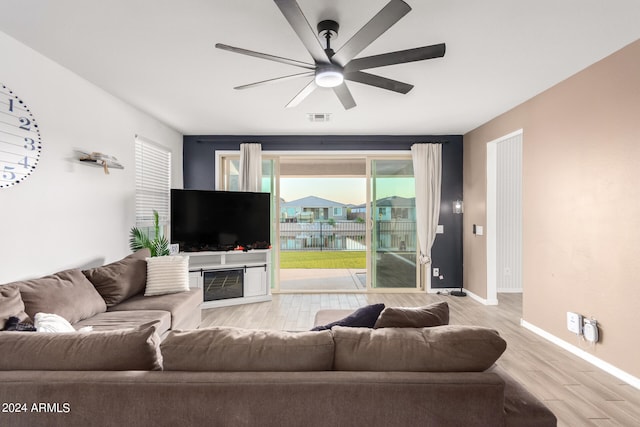 living room with light wood-type flooring and ceiling fan