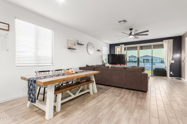 living room featuring light hardwood / wood-style floors and ceiling fan