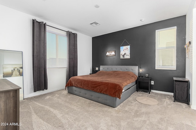 bedroom featuring light carpet