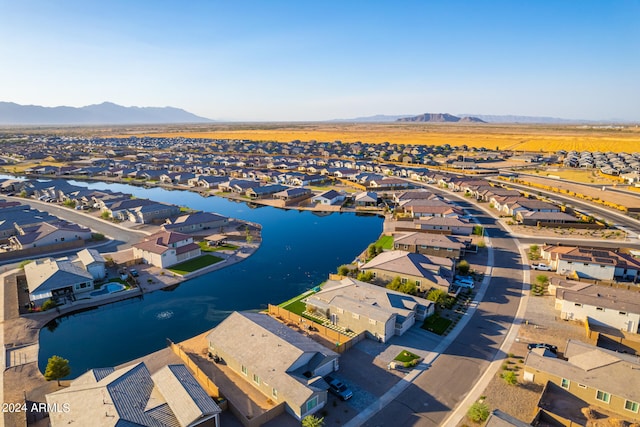 drone / aerial view with a water and mountain view