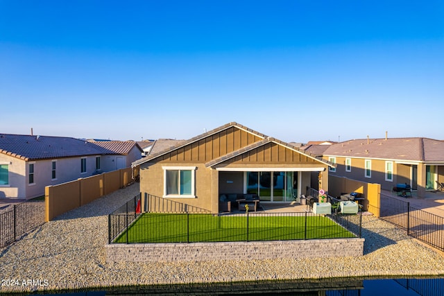 view of front facade with an outdoor hangout area, a front lawn, and a patio