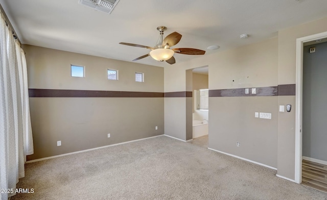 carpeted empty room featuring ceiling fan