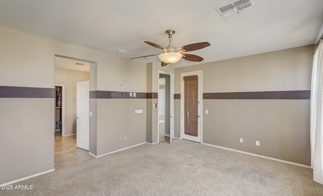 carpeted empty room featuring ceiling fan