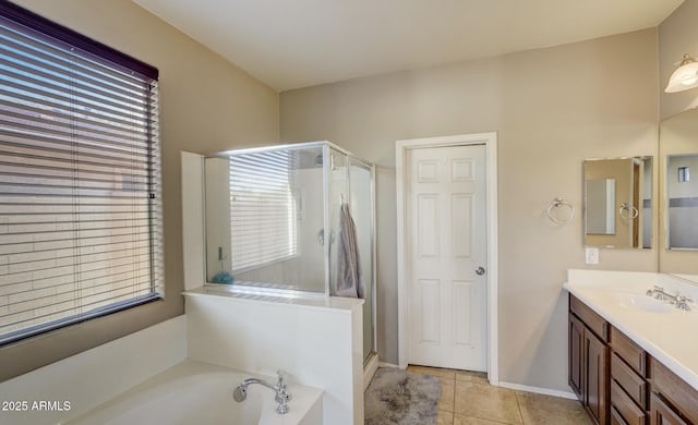 bathroom with tile patterned floors, vanity, and separate shower and tub