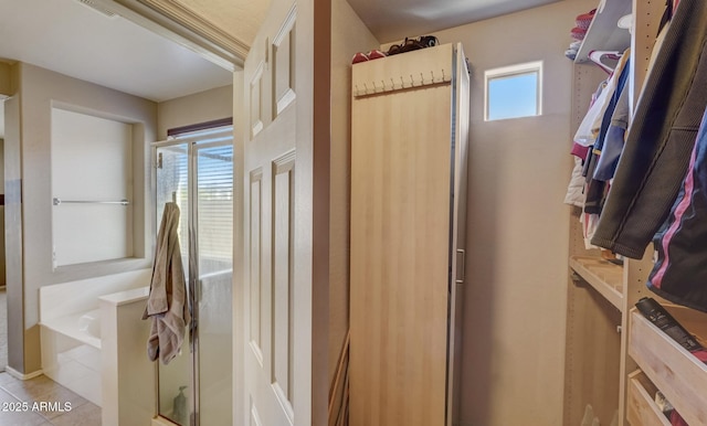 bathroom featuring tile patterned floors and plus walk in shower