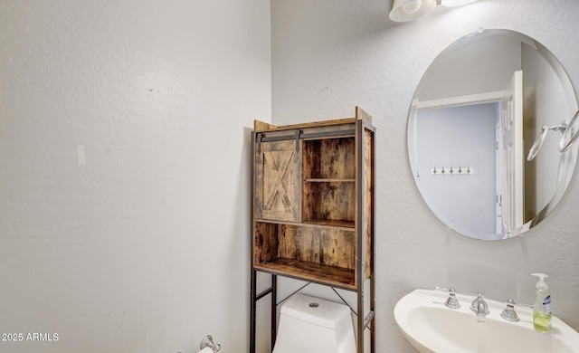 bathroom featuring toilet and sink