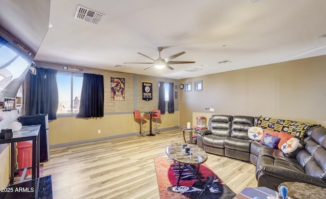 living room with ceiling fan and light wood-type flooring