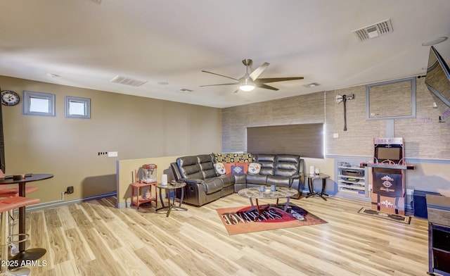 living room with light hardwood / wood-style flooring and ceiling fan