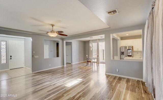 foyer entrance featuring ceiling fan and light hardwood / wood-style flooring