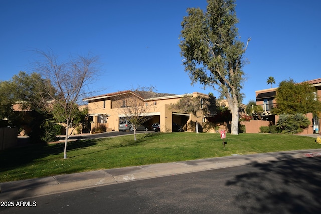 view of front of house with a garage and a front lawn