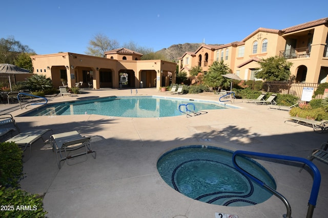 view of pool with a community hot tub and a patio