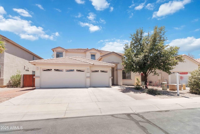 43525 W Cydnee Dr, Maricopa, AZ 85138 - view of front facade featuring stucco siding, a garage, a tiled roof, and driveway